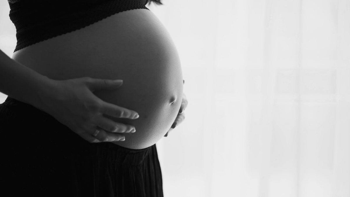 pregnant woman experiencing foot pain and discomfort