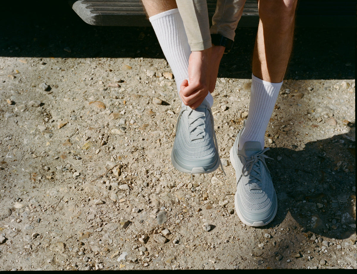 person putting on wide toe box shoes
