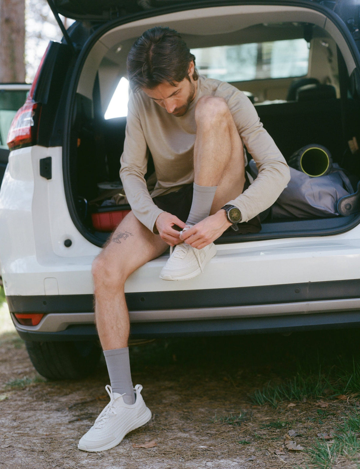 man putting on and tying shoes for overpronation